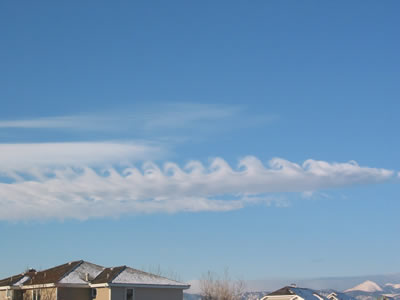 <a href="/earth/Atmosphere/clouds/kelvin_helmholtz.html&dev=">Kelvin-Helmholtz</a>
  clouds resemble breaking <a
  href="/earth/Water/ocean_waves.html&dev=">waves in
  the ocean</a>. They are usually the most developed near mountains or large
  hills. Wind deflected up and over a barrier, like a mountain, continues
  flowing through the air in a wavelike pattern. Complex <a
  href="/earth/Water/evaporation.html&dev=">evaporation</a>
  and <a href="/earth/Water/condensation.html&dev=">condensation</a>
  patterns create the capped tops and cloudless troughs of the waves. This
  image was taken on February 9, 2003 in the morning in Boulder, Colorado.<p><small><em>       Courtesy of Roberta Johnson</em></small></p>