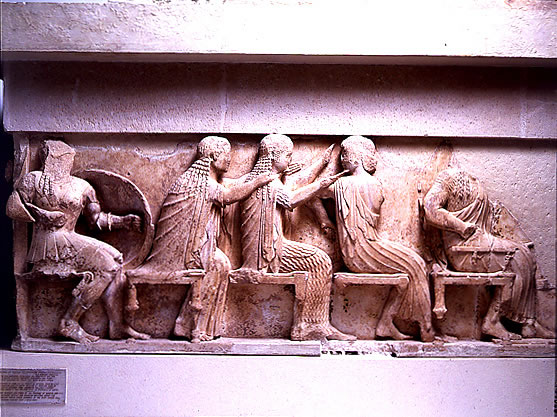 Left 
section of the east frieze of the Siphnian Treasury (c. 525 B.C.) depicting 
from left to right <a 
href="/mythology/Definitions_gods/Venus_def.html">
Venus</a>, <a 
href="/mythology/Diana_def.html">
Diana</a>, and <a 
href="/mythology/Definitions_gods/Apollo_def.html">
Apollo</a>. This portion of the frieze shows the gods sitting, watching the 
Greeks raid Troy.<p><small><em>   Image courtesy of the Superintendency (Ephoria) of Prehistoric and Classical Antiquities in Delphi. Greek Ministry of Culture-Archaeological Receipt Fund. (c) Greek Ministry of Culture.</em></small></p>